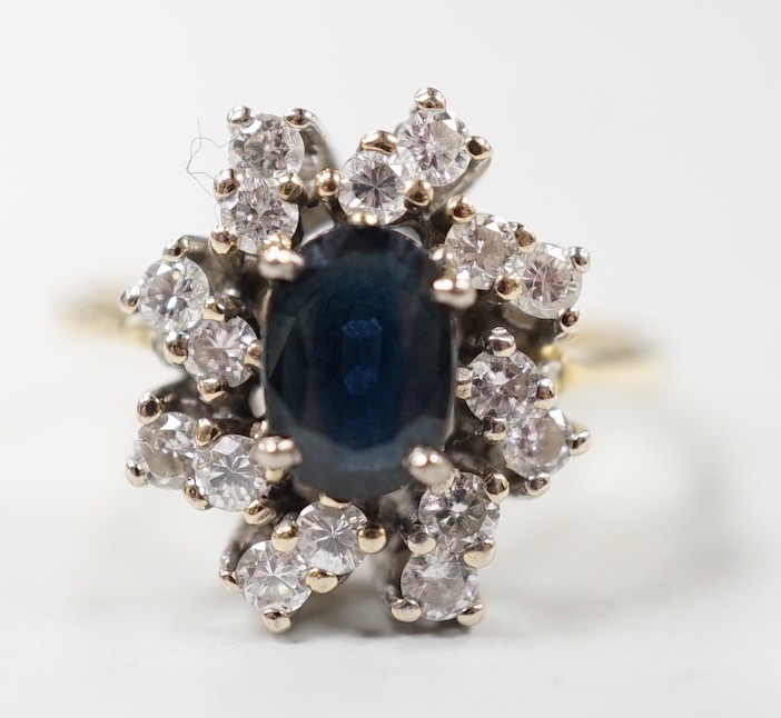 A modern 18ct gold, sapphire and diamond set oval cluster ring, size L, gross weight 4.8 grams.